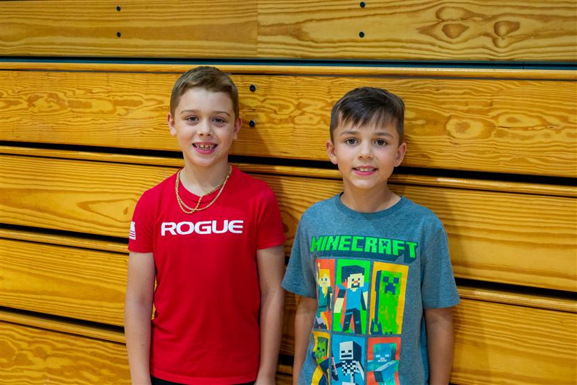 Students smile during an assembly